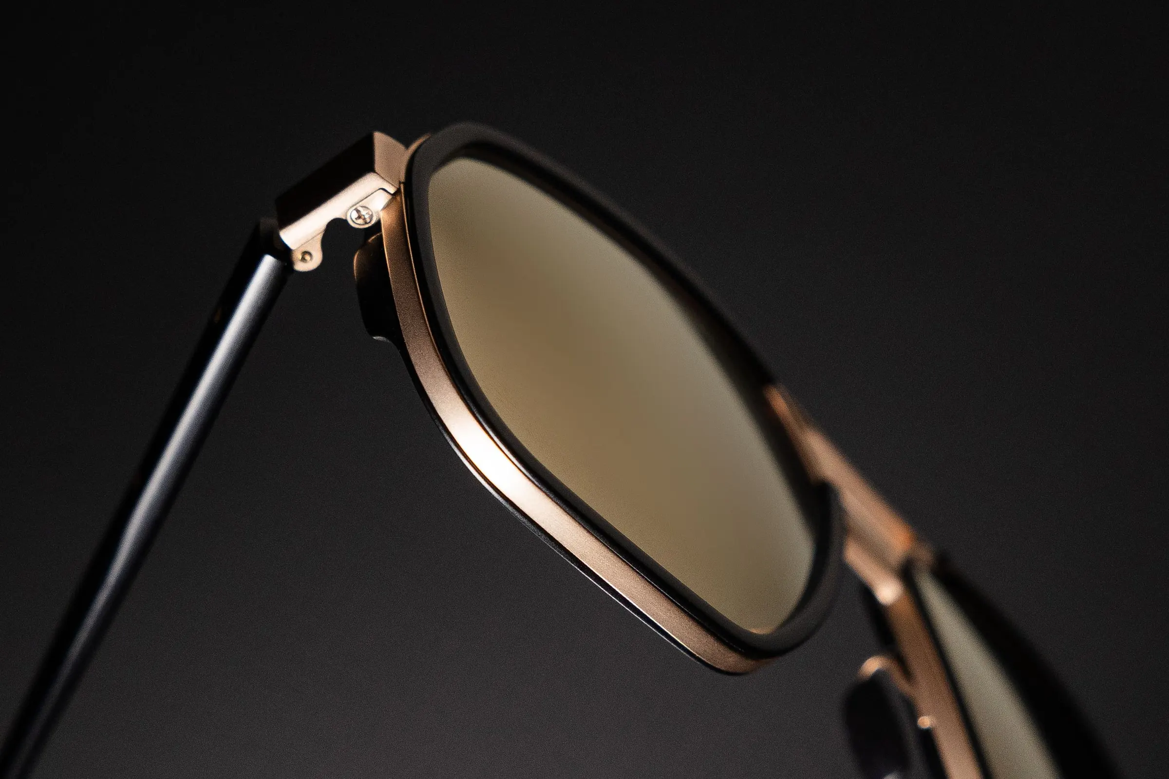 Lunettes de soleil à monture fine posées dans la pénombre